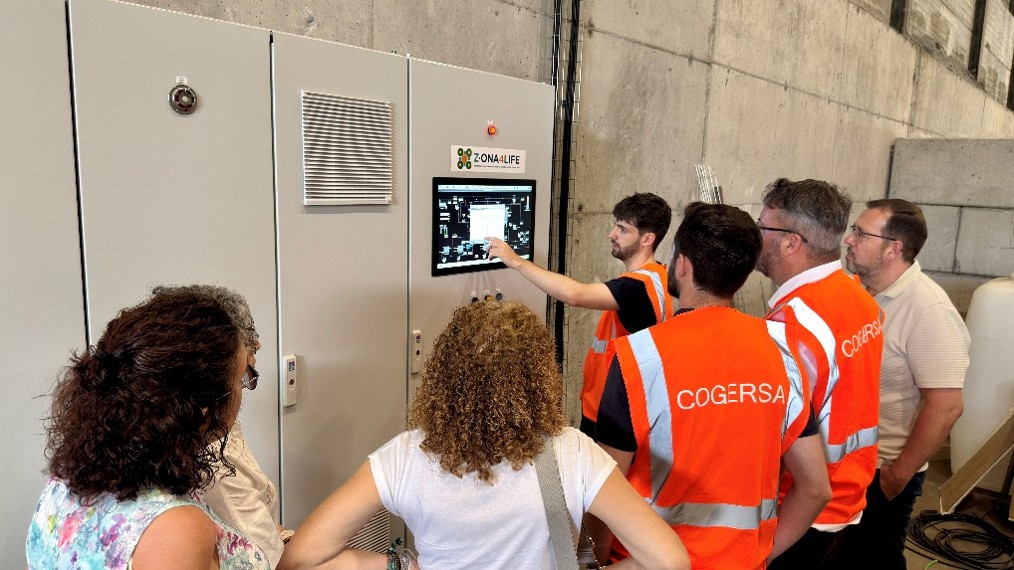 People looking at the electrical control panel